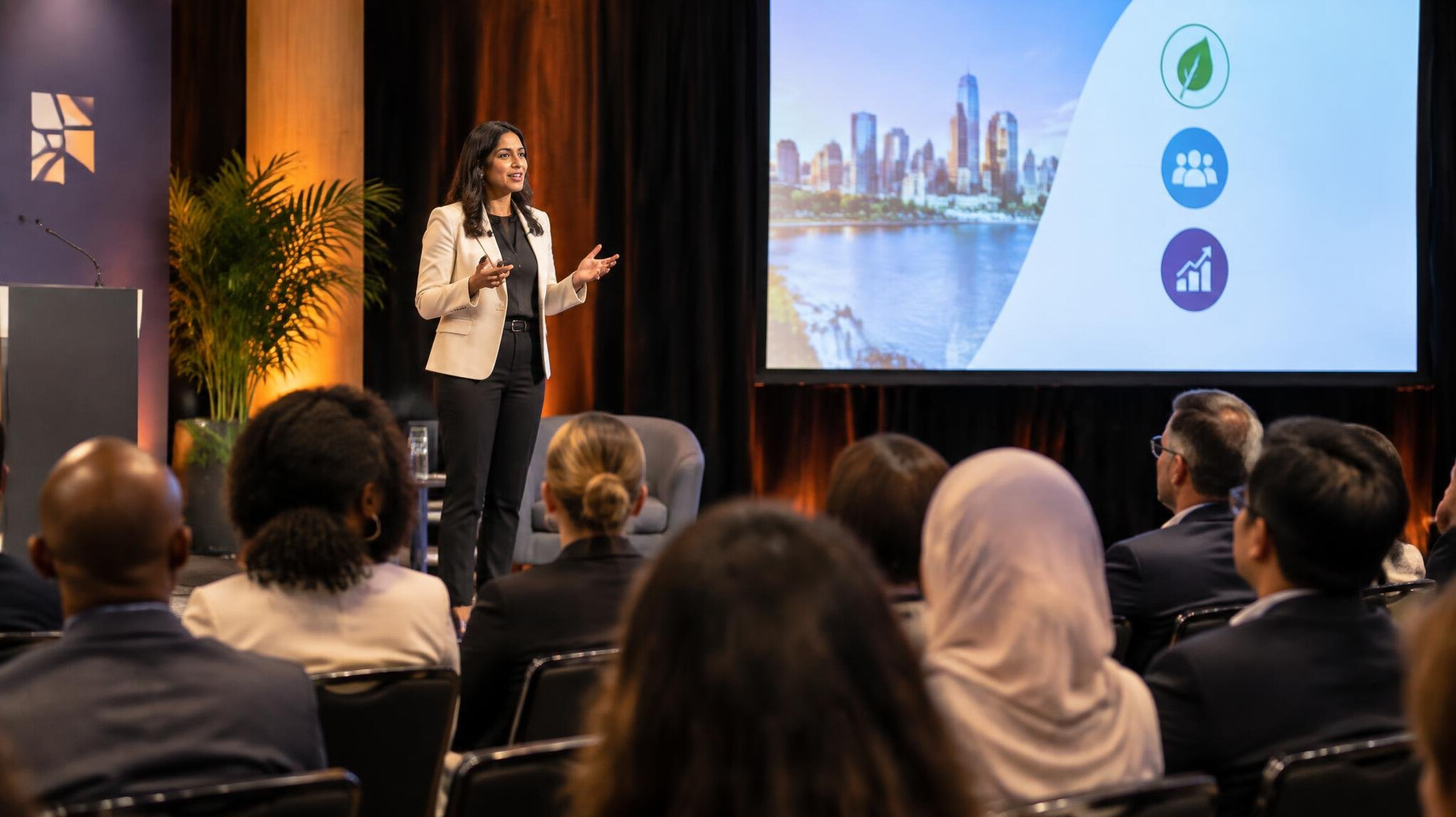 Speaker presenting to an audience at a business forum