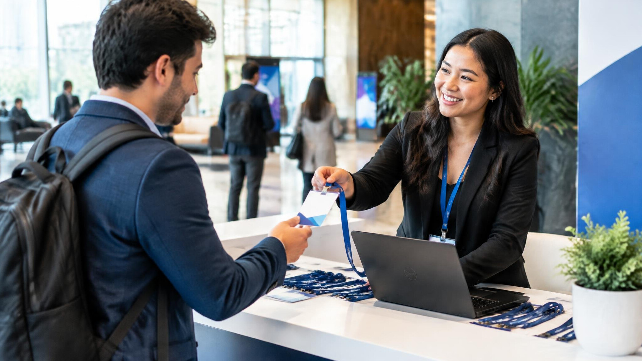 Attendee receiving a badge at an event check-in desk